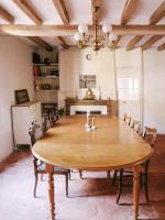a dining room with a wooden table and chairs at La Maison Pieuse in Villiers-Saint-Benoît