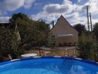 a swimming pool in front of a house at Maison Marilene in Ajat
