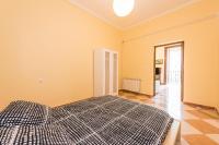 Łóżko lub łóżka w pokoju w obiekcie Grand Latina Apartment