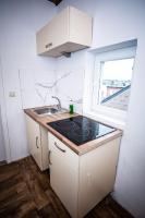 a small kitchen with a sink and a window at Belle chambre sur liège in Liège