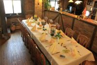 a long table in a restaurant with white tables and chairs at Land gut Hotel Hermann in Bentwisch