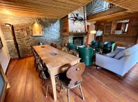 a dining room with a wooden table and chairs at Chalet Altus in Sainte-Foy-Tarentaise