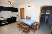 a kitchen with a table and chairs with a blue table at Apartment Jezera 5057b in Jezera