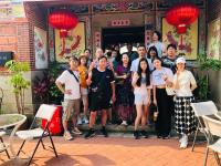 a group of people posing for a picture in front of a building at I-Shan B&amp;B in Jincheng