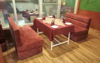 a table with two chairs and a red table and chairs at The Royal Bhumesh in Katra