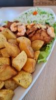 a plate of food with shrimp and potatoes on a table at Golf Ville Resort Brisa do Golf -Apartamentos e Cobertura in Aquiraz