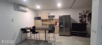 a kitchen with a black table and a refrigerator at AppartGrasseBBQ in Grasse