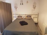 a bedroom with a large bed in a room at Appartement Ré (4 personnes) in Châtelaillon-Plage