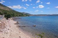 a body of water with a beach and a road at Apartment Seline 11197b in Starigrad