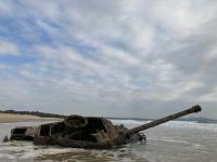 a boat sitting in the water on the beach at Shenten Homestay in Jincheng