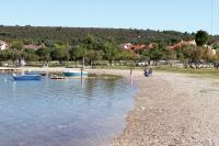 a group of people on a beach with boats in the water at Studio Sukosan 14681a in Sukošan