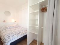 a bedroom with a bed and a white closet at L&#39;Atelier d&#39;Oscar in Le Havre