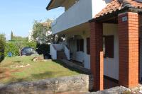 a house with a brick pillar and a yard at Apartments with a parking space Karigador, Novigrad - 2534 in Karigador