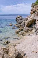 a group of rocks on the shore of the ocean at Apartments by the sea Pisak, Omis - 1018 in Pisak