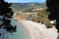 a view of a sandy beach next to the water at Apartments and rooms by the sea Komiza, Vis - 2431 in Komiža