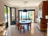 a dining room with a table and chairs in a room at Bienvenue au Mas du Roulier, villa provençale avec vue hypnotique sur la chaine des Puys in Thiers