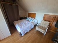 a small bedroom with a bed and a chair at LE GALOPIN Etaples le Touquet in Étaples