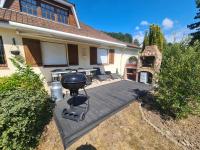 a backyard with a grill and a table and chairs at LE GALOPIN Etaples le Touquet in Étaples
