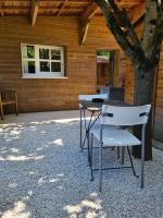 a table and chairs in front of a cabin at Charmant logement avec parking in Orvault