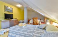 a bedroom with a large bed with a tv on the wall at Gorgeous Home In Slunj With Kitchen in Slunj