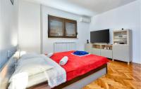 a bedroom with a large bed with a red blanket at Gorgeous Home In Slunj With Kitchen in Slunj