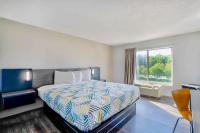 a hotel room with a bed and a window at Motel 6 Virginia Beach in Virginia Beach