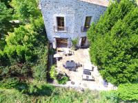 an aerial view of a stone house with tables and chairs at Au bout du pré in Pézenas