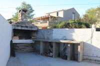 an outdoor kitchen with a counter and a fireplace at Studio Rukavac 8863a in Rukavac