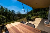 a wooden table and chairs on a patio with a view at The cabin Morris in Holsbeek