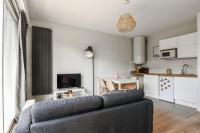 a living room with a couch and a kitchen at Beautiful apartment with a balcony in the heart of Lille - Welkeys in Lille