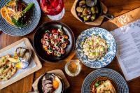 a table topped with plates of food and bowls of food at InterContinental Perth City Centre by IHG in Perth