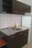 a kitchen with a sink and a refrigerator at Apartment Seline 11197b in Starigrad