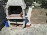 a stone oven sitting on top of a yard at Apartments with a parking space Betina, Murter - 11322 in Betina