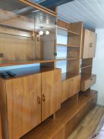 a large wooden cabinet with glass doors at Studio indépendant dans un maison in Saint-Denis