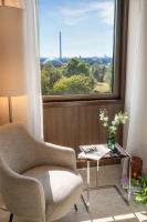 a chair and a table in a room with a window at Meliá Düsseldorf in Düsseldorf