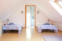 a attic room with two beds and a mirror at Lescoat-le petit paradis in Plestin-les-Grèves