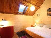 a bedroom with a bed in a wooden cabin at Appartement Saint-Chaffrey , 3 pièces, 6 personnes - FR-1-330E-106 in Saint-Chaffrey