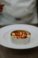 a small bowl of food on a white plate at Ah Porticcioli Boutique Apartments in San Felice del Benaco