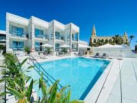 a swimming pool in front of a building at Hotel Apartamentos Marina Luz in Chipiona