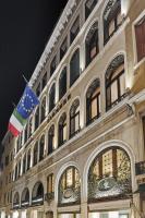 a building with two flags on the side of it at Hotel Firenze in Venice