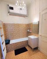 a bathroom with a sink and a chandelier at Grand studio 38m2 dans ancien palace avec piscine et place de parking privée in Aix-les-Bains