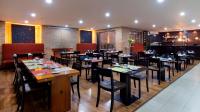 a restaurant with tables and chairs in a room at Hotel Madisson Inn Luxury By GEH Suites in Bogotá