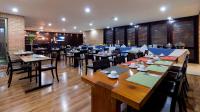 a restaurant with tables and chairs in a room at Hotel Madisson Inn Luxury By GEH Suites in Bogotá