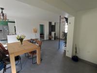 a living room with a wooden table and chairs at Nancy - Maison chaleureuse in Champigneulles