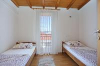 two beds in a room with a window at Apartment Okrug Donji 16657b in Okrug Donji