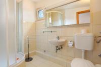 a bathroom with a toilet and a sink and a shower at Apartment Okrug Donji 16657b in Okrug Donji