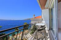 a balcony with a table and chairs overlooking the water at Apartment Okrug Donji 16657b in Okrug Donji