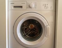 a white washing machine with its door open at Beautiful apartment * parking* Disneyland 10 min in Montévrain