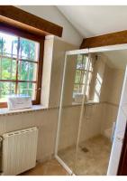 a bathroom with a shower with a glass shower stall at Manoir du Suquet in Bardou