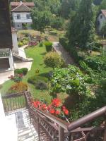 a garden with flowers and a bench on a balcony at Apartmani Mali Raj Rudnik in Rudnik
